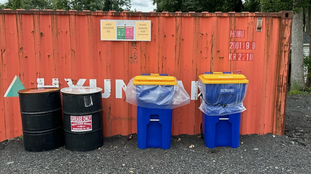 Food and grease bins against a shipping container